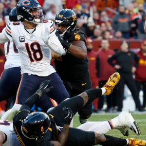 Chicago Bears quarterback Caleb Williams (18) passes the ball as Washington Commanders linebacker Frankie Luvu (4) and Commanders linebacker Bobby Wagner (54) defend during the second quarter at Northwest Stadium.