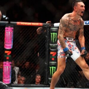 Max Holloway (blue gloves) reacts after defeating Justin Gaethje (red gloves) during UFC 300 at T-Mobile Arena