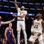 Oct 26, 2024; Los Angeles, California, USA; Los Angeles Lakers forward Anthony Davis (3) shoots against Sacramento Kings forward Domantas Sabonis (11) during the second half at Crypto.com Arena. Mandatory Credit: Jonathan Hui-Imagn Images