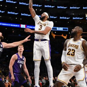Oct 26, 2024; Los Angeles, California, USA; Los Angeles Lakers forward Anthony Davis (3) shoots against Sacramento Kings forward Domantas Sabonis (11) during the second half at Crypto.com Arena. Mandatory Credit: Jonathan Hui-Imagn Images