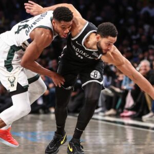 Milwaukee Bucks forward Giannis Antetokounmpo (34) and Brooklyn Nets guard Ben Simmons (10) fight for a loose ball in the fourth quarter at Barclays Center.