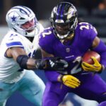 Sep 22, 2024; Arlington, Texas, USA; Baltimore Ravens running back Derrick Henry (22) runs with the ball as Dallas Cowboys linebacker Micah Parsons (11) defends during the second half at AT&T Stadium.