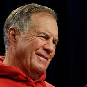Bill Belichick smiles during questions at a press conference.
