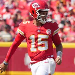 Aug 17, 2024; Kansas City, Missouri, USA; Kansas City Chiefs quarterback Patrick Mahomes (15) throws a behind-the-back underhand pass to tight end Travis Kelce (87) (not pictured) against the Detroit Lions during the first half at GEHA Field at Arrowhead Stadium.