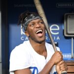 British YouTuber KSI and cruiserweight professional boxer swings a bat in the dugout prior to the game between the Los Angeles Dodgers and the Arizona Diamondbacks at Dodger Stadium