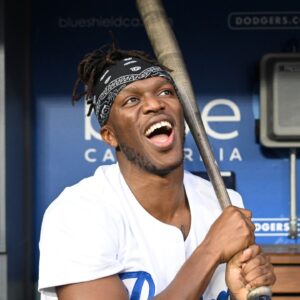 British YouTuber KSI and cruiserweight professional boxer swings a bat in the dugout prior to the game between the Los Angeles Dodgers and the Arizona Diamondbacks at Dodger Stadium