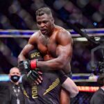 Francis Ngannou (red gloves) celebrates after the fight against Ciryl Gane (blue gloves) during UFC 270 at Honda Center.