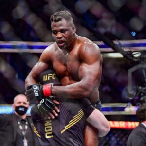 Francis Ngannou (red gloves) celebrates after the fight against Ciryl Gane (blue gloves) during UFC 270 at Honda Center.