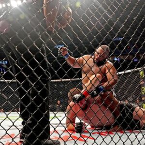 Jake Collier (red gloves) fights Chris Barnett (blue gloves) during UFC 279 at T-Mobile Arena.