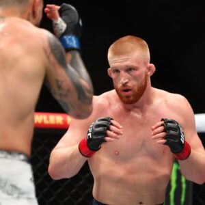 Bo Nickal (red gloves) fights Cody Brundage (blue gloves) during UFC 300 at T-Mobile Arena.