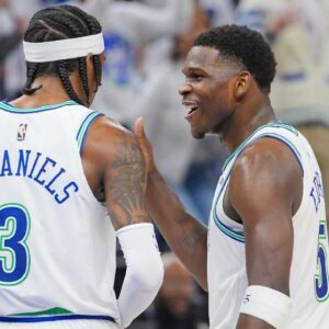 Minnesota Timberwolves guard Anthony Edwards (5) and forward Jaden McDaniels (3) talk in the third quarter against the Denver Nuggets during game six of the second round for the 2024 NBA playoffs at Target Center.