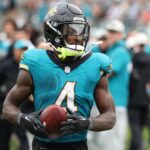 Jacksonville Jaguars running back Tank Bigsby (4) takes the ball to the sidelines after his touchdown in the game between the Indianapolis Colts and Jacksonville Jaguars