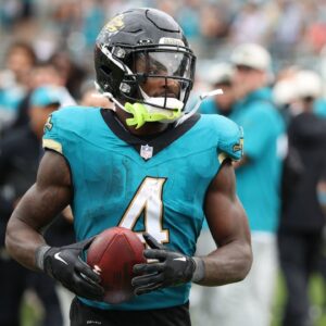 Jacksonville Jaguars running back Tank Bigsby (4) takes the ball to the sidelines after his touchdown in the game between the Indianapolis Colts and Jacksonville Jaguars