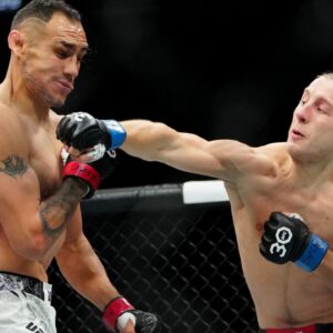 Tony Ferguson (red gloves) fights Paddy Pimblett (blue gloves) during UFC 296 at T-Mobile Arena. Mandatory