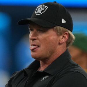 Las Vegas Raiders head coach Jon Gruden looks on as his players warm up before a game against the Los Angeles Chargers at SoFi Stadium.