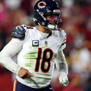 Chicago Bears quarterback Caleb Williams (18) celebrates after the Bears scored a touchdown during the fourth quarter against the Washington Commanders at Commanders Field.