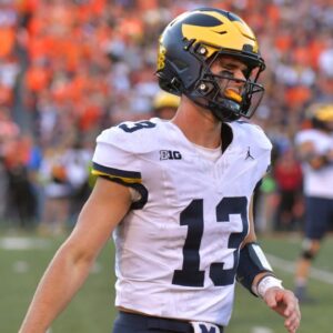 Michigan Wolverines quarterback Jack Tuttle (13) reacts after turning over possession of the ball against the Illinois Fighting Illini during the second half at Memorial Stadium
