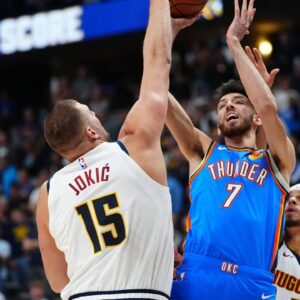 Denver Nuggets center Nikola Jokic (15) defends on Oklahoma City Thunder forward Chet Holmgren (7) in the first quarter at Ball Arena.
