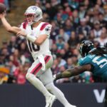 New England Patriots quarterback Drake Maye (10) throws the ball against Jacksonville Jaguars defensive tackle DaVon Hamilton (52) in the first half of an NFL International Series game at Wembley Stadium.