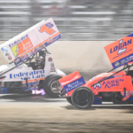 Logan Schuchart (1s) and Giovanni Scelzi (18) race down the front straight in the World of Outlaws Larry Hillerud Badger 40 on Friday, July 12, 2024, at the Wilmot Raceway in Wilmot, Wisconsin.