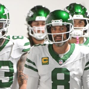 New York Jets quarterback Aaron Rodgers (8) walks onto the field for a game against the Pittsburgh Steelers at Acrisure Stadium.