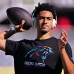 Carolina Panthers quarterback Bryce Young (9) warms up before the game against the Chicago Bears at Soldier Field.