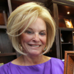 Betty Jane France holds her favorite photograph of her late husband Bill France Jr., on Wednesday May 15, 2013 in her office.