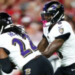 Oct 21, 2024; Tampa, Florida, USA; Baltimore Ravens quarterback Lamar Jackson (8) hands off to running back Derrick Henry (22) against the Tampa Bay Buccaneers in the first quarter at Raymond James Stadium.