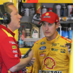 NASCAR Sprint Cup Series driver Joey Logano (right) talks to crew chief Todd Gordon (left) during practice for the Windows 10 400 at Pocono Raceway.