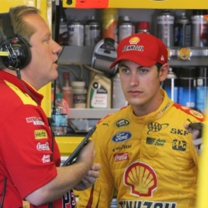NASCAR Sprint Cup Series driver Joey Logano (right) talks to crew chief Todd Gordon (left) during practice for the Windows 10 400 at Pocono Raceway.