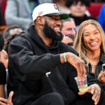 Los Angeles Laker LeBron James and his wife Savannah James sit court side at the McDonald's All American game during the first half at Toyota Center.
