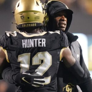 Colorado Buffaloes wide receiver Travis Hunter (12) is congratulated for his touchdown by head coach Deion Sanders in the first quarter against the Stanford Cardinal at Folsom Field.