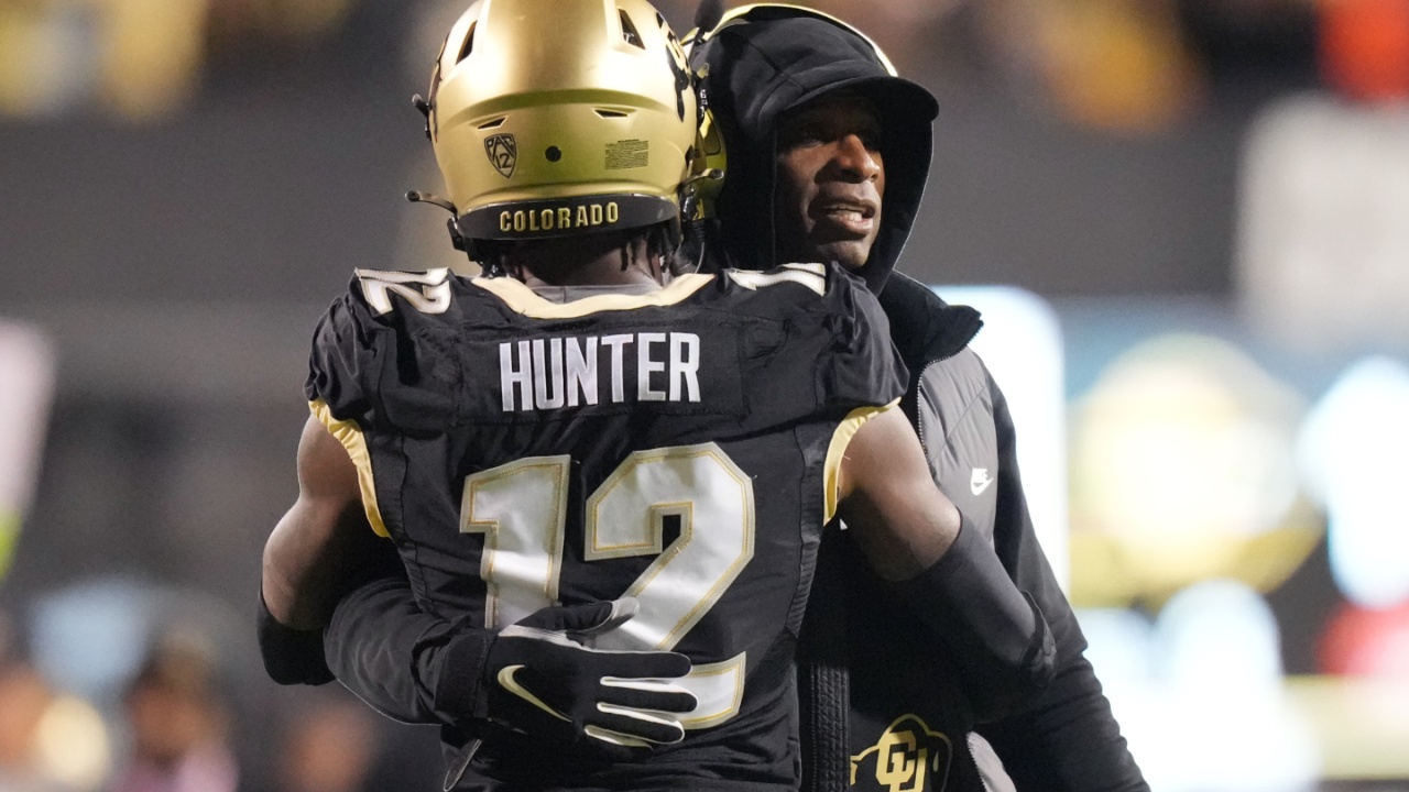 Colorado Buffaloes wide receiver Travis Hunter (12) is congratulated for his touchdown by head coach Deion Sanders in the first quarter against the Stanford Cardinal at Folsom Field.