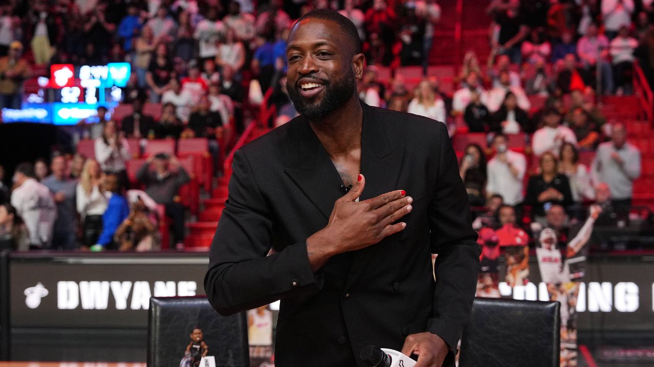 Former Miami Heat player Dwayne Wade acknowledges the fans and cameras after a special ceremony during halftime of the game between the Miami Heat and the Charlotte Hornets at Kaseya Center.