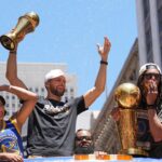 Golden State Warriors guard Stephen Curry (middle left) gestures while standing with wife Ayesha (far left) and guard Damion Lee (middle right) and his wife Sydel Curry (far right) during the Golden State Warriors championship parade in downtown San Francisco.