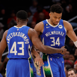 Milwaukee Bucks forward Giannis Antetokounmpo (34) hugs his brother, Bucks forward Thanasis Antetokounmpo (43), while walking off the floor against the Washington Wizards