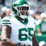 Aug 10, 2024; East Rutherford, New Jersey, USA; New York Jets guard Xavier Newman (65) looks on before the game against the Washington Commanders at MetLife Stadium.