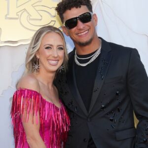 Kansas City Chiefs quarterback Patrick Mahomes and wife Brittany pose for a photo on the red carpet at the Nelson Art Gallery.