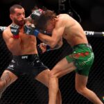 Dan Ige (red gloves) fights Diego Lopes (blue gloves) during UFC 303 at T-Mobile Arena. Mandatory