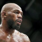 on Jones (red gloves) fights Dominick Reyes (not pictured) during UFC 247 at Toyota Center.