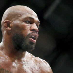 on Jones (red gloves) fights Dominick Reyes (not pictured) during UFC 247 at Toyota Center.