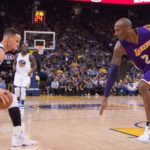 Golden State Warriors guard Stephen Curry (30, left) dribbles the basketball against Los Angeles Lakers forward Kobe Bryant (24) during the first quarter at Oracle Arena. The Warriors defeated the Lakers 116-98.