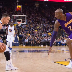 Golden State Warriors guard Stephen Curry (30, left) dribbles the basketball against Los Angeles Lakers forward Kobe Bryant (24) during the first quarter at Oracle Arena. The Warriors defeated the Lakers 116-98.