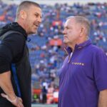 Nov 16, 2024; Gainesville, Florida, USA; Florida Gators head coach Billy Napier and LSU Tigers head coach Brian Kelly talk midfield before a game at Ben Hill Griffin Stadium.