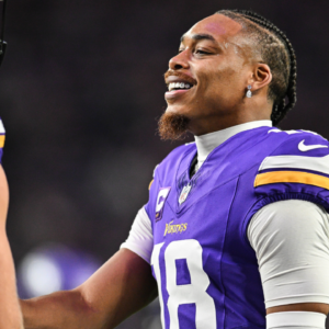 Minnesota Vikings wide receiver Justin Jefferson (right) reacts with tight end T.J. Hockenson (87) before the game against the Indianapolis Colts at U.S. Bank Stadium.