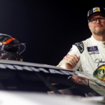 Dale Earnhardt Jr. waits next to his during qualifying for the 16th Annual Hampton Heat at Langley Speedway.