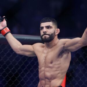 Amir Albazi (red gloves) reacts after defeating Francisco Figueiredo (blue gloves) during UFC 278 at Vivint Arena.