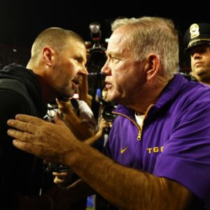 LSU Tigers head coach Brian Kelly and Florida Gators head coach Billy Napier greet after the game at Ben Hill Griffin Stadium.