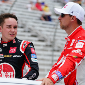 NASCAR Cup Series driver Christopher Bell (20) and NASCAR Cup Series driver Denny Hamlin (11) ride to pit road before the start of the Quaker State 400 at Atlanta Motor Speedway.