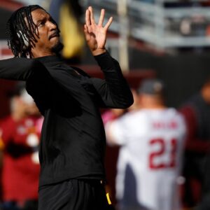 Washington Commanders quarterback Jayden Daniels warms up prior to putting on pads before the game against the Chicago Bears at Commanders Field.